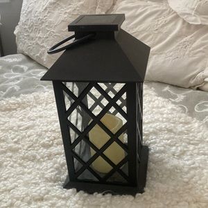 Solar power lantern with flickering candle inside when powered